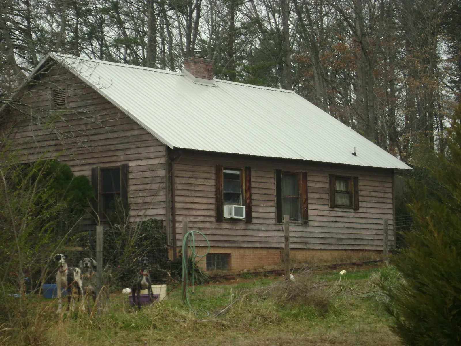White metal roof on an old wood sided farmhouse, from a Metal Roof Installation job in Moorefield